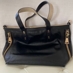 Genuine leather. Made in Italy. Gold side zippers.